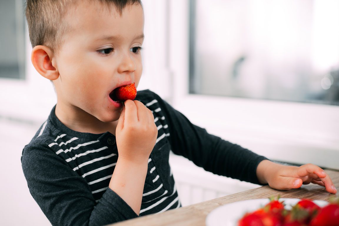 boy eating strawberry